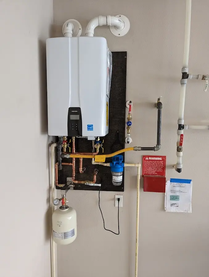 Professional plumber installing copper piping in a West Modesto home